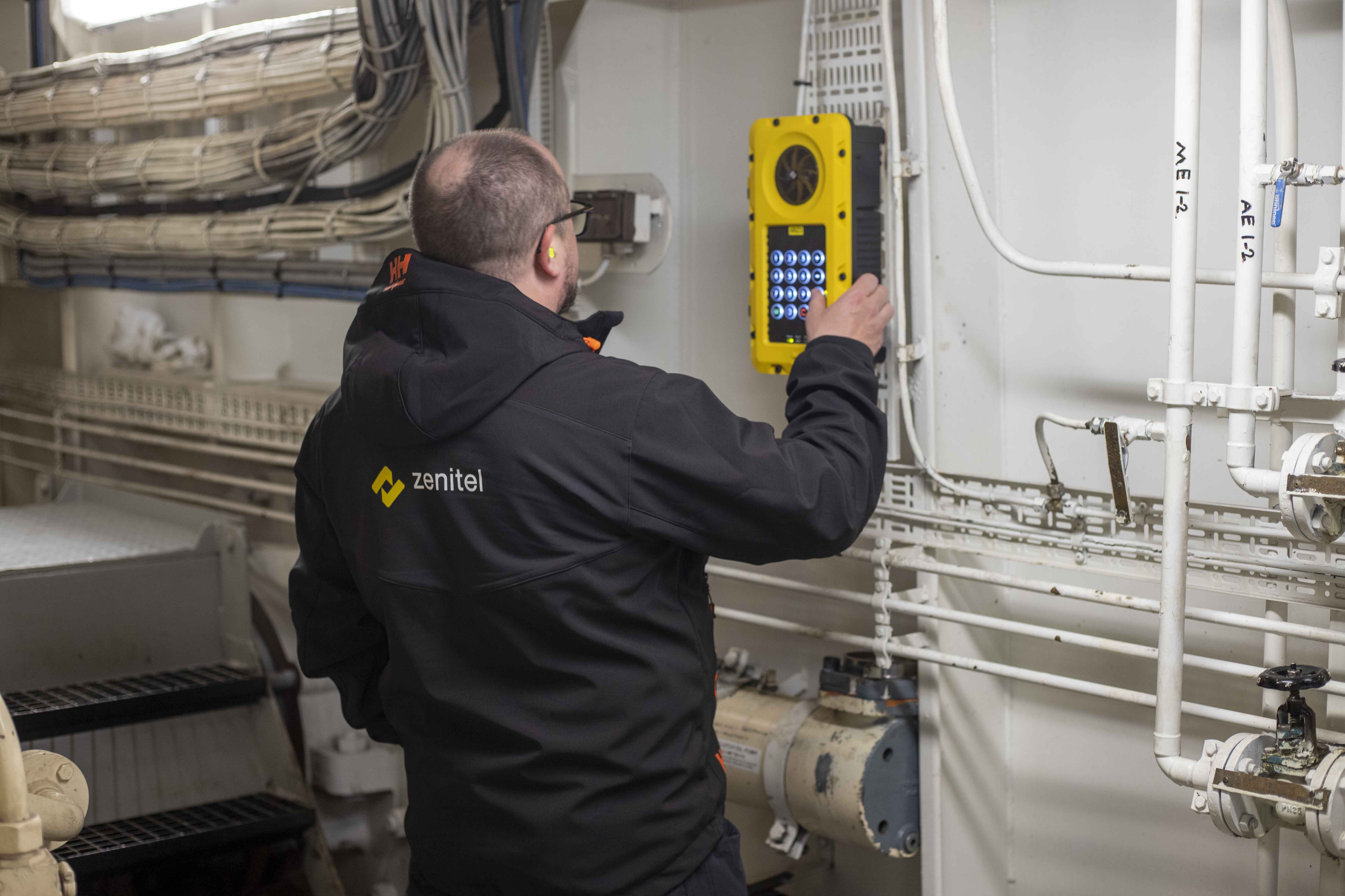 Zenitel engineer testing a TFIE intercom station in the engine room during retrofit of onboard communication system on Silja Serenade.