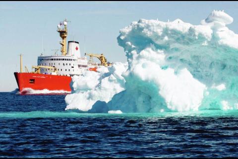 The Canadian Coast Guard icebreaker Louis S. St-Laurent sails past a iceberg in Lancaster Sound,