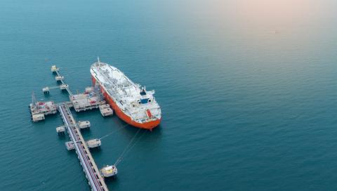 Tanker vessel docked at petroleum yard, with onboard communication for tanker vessels