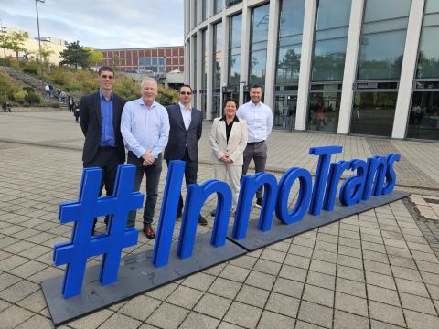 Zenitel team pose by the Innotrans sign