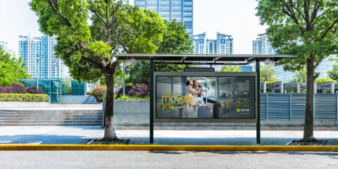 BUs stop at a city with greenery around it